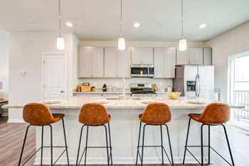 Kitchen with island counter and stools